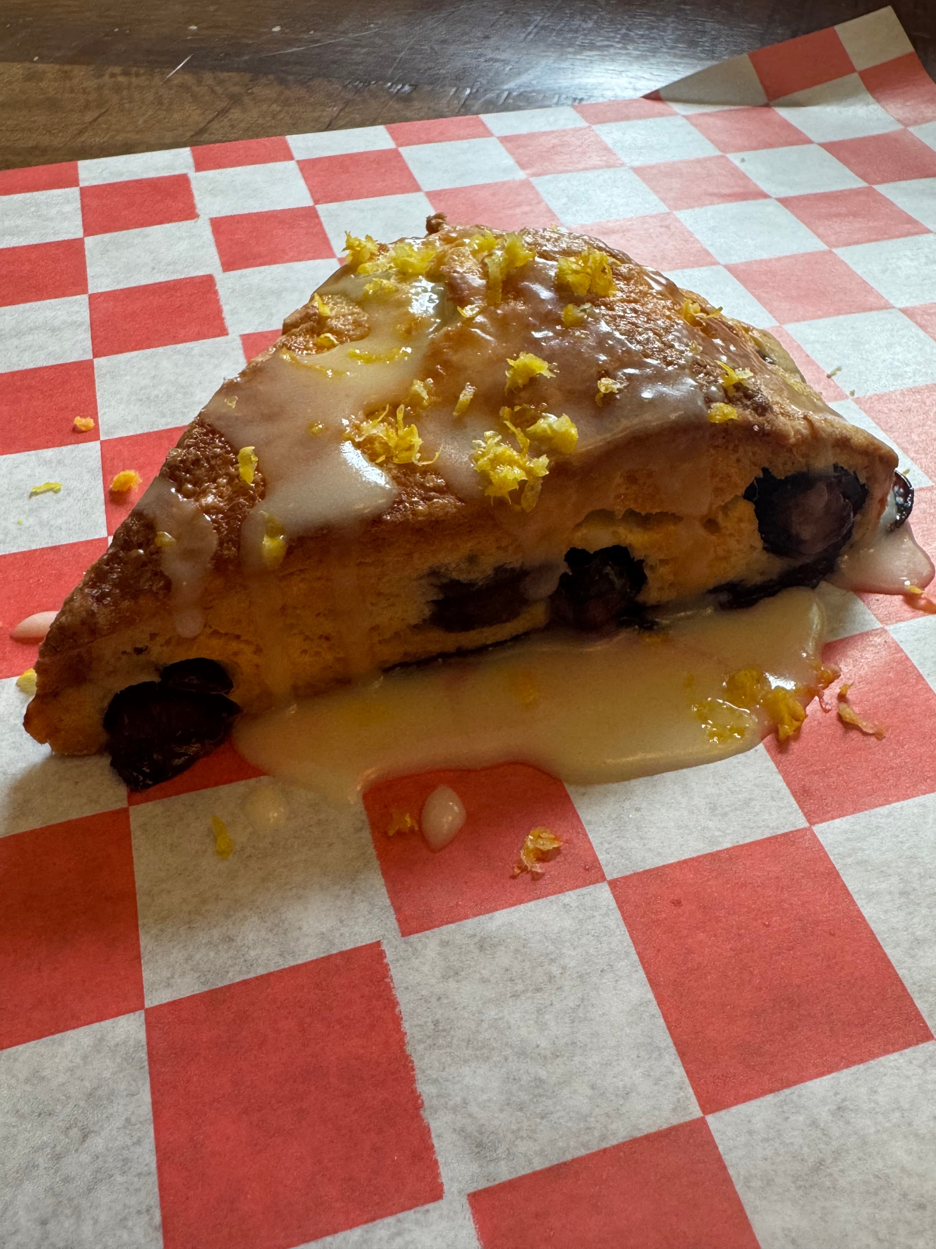 Glazed blueberry lemon scone with lemon zest