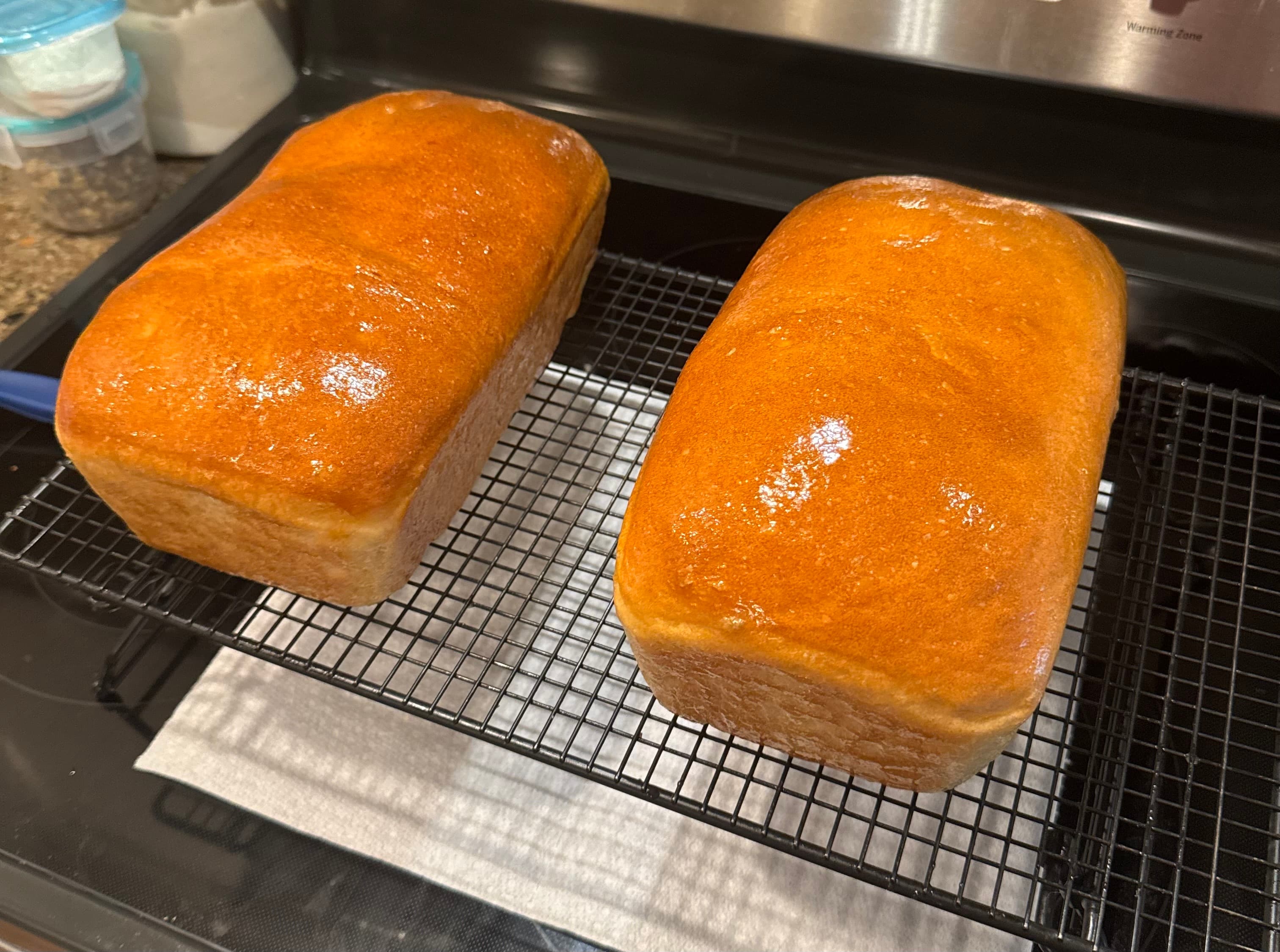 Golden brown bread loaves cooling on wire rack
